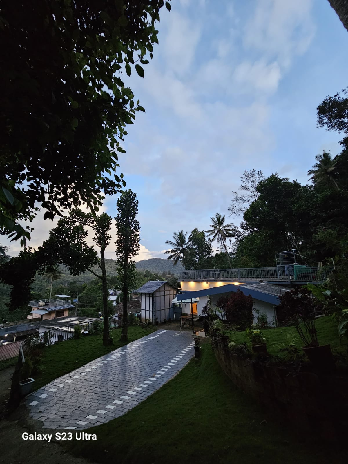 Spacious outdoor seating area at Bhaskar Home surrounded by tropical plants